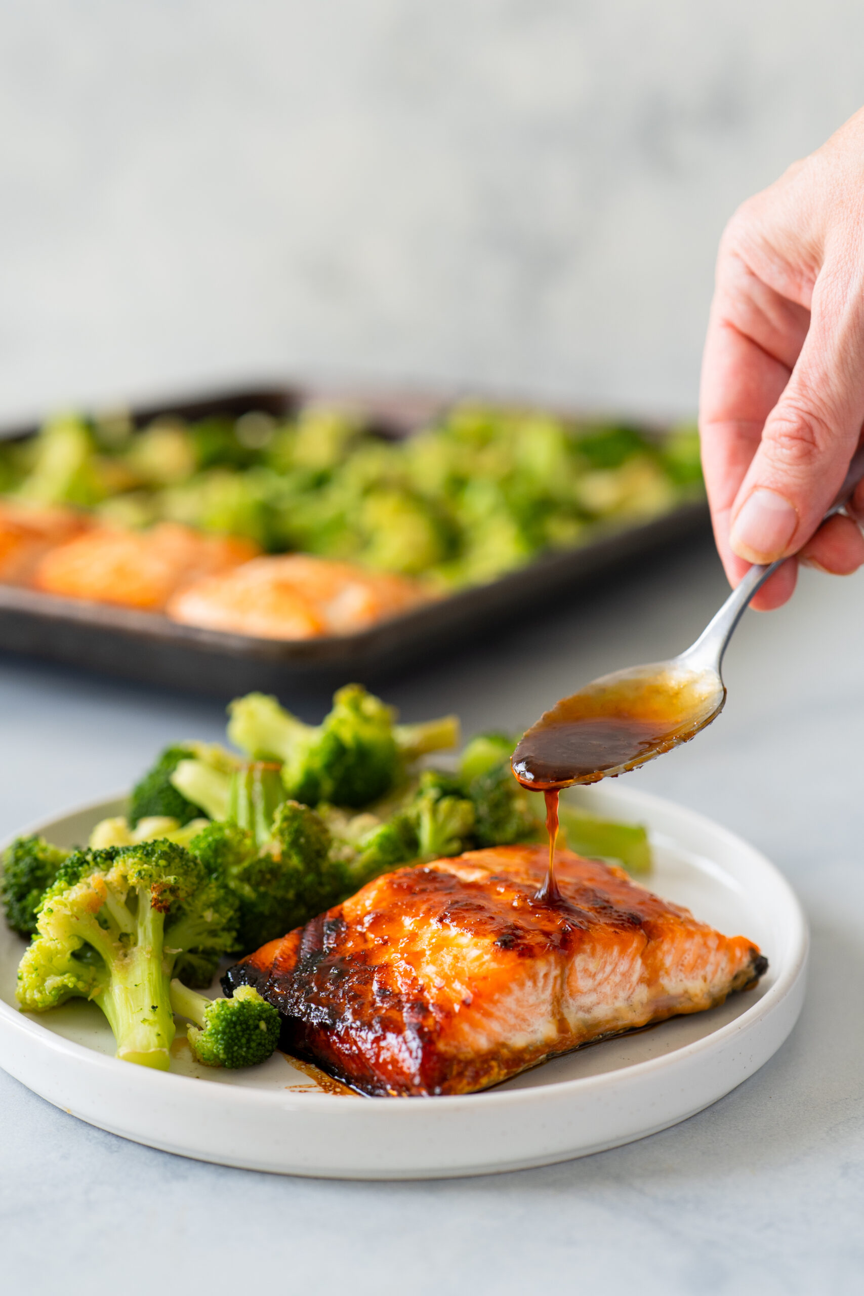 Interior cookbook spread from Cleanish Meal Prep featuring sheet-pan chicken fajitas portioned into meal prep containers, highlighting real-life meals that store well, reheat easily, and simplify healthy eating.