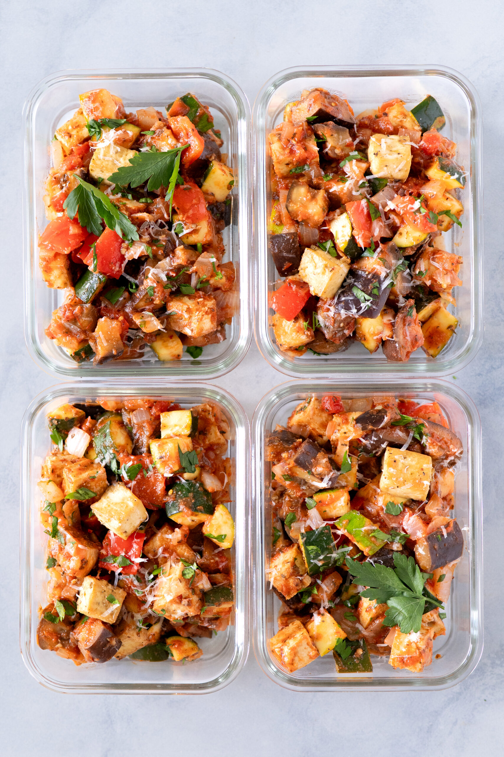 Interior cookbook spread from Cleanish Meal Prep featuring sheet-pan chicken fajitas portioned into meal prep containers, highlighting real-life meals that store well, reheat easily, and simplify healthy eating.